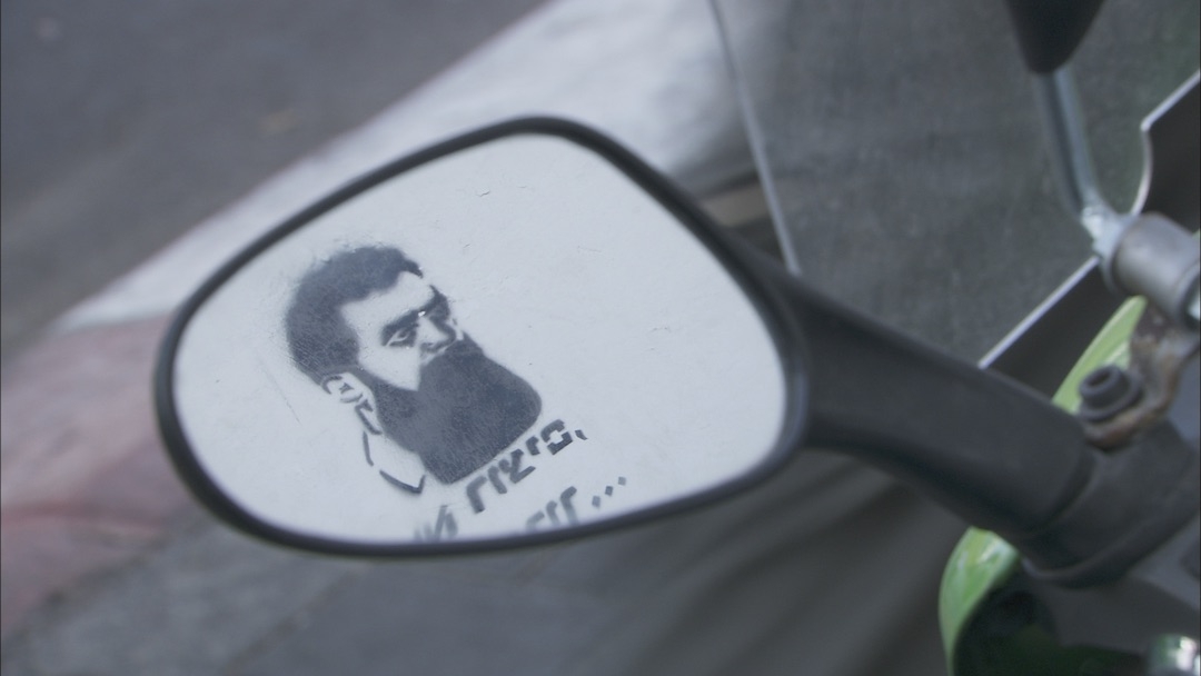 Herzl graffiti in the rearview mirror