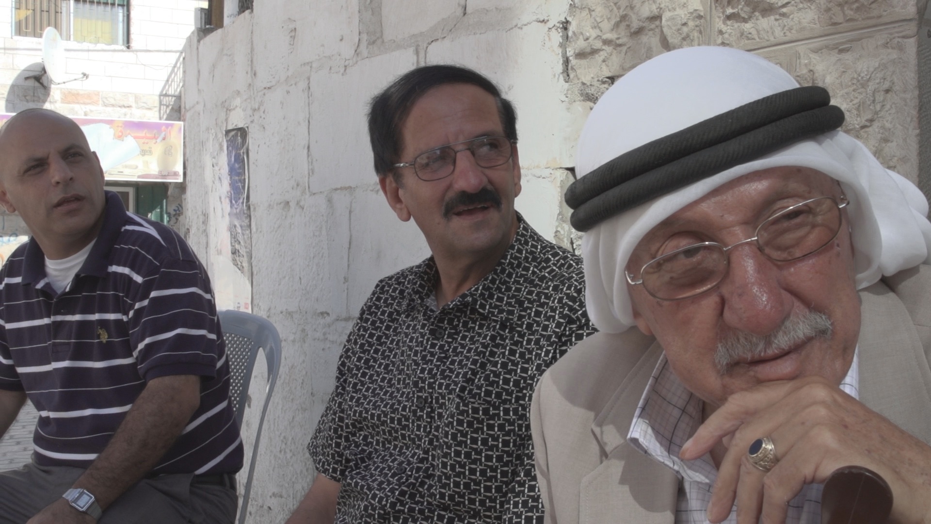 Three Arab men in front of cafe Al Birra West Bank